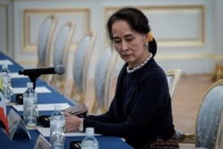 FILE - Myanmar's State Counsellor Aung San Suu Kyi waits for the arrival of her delegation before the Japan Myanmar Summit meeting in Tokyo, Japan, Oct. 9, 2018.