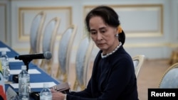 FILE - Myanmar's State Counsellor Aung San Suu Kyi waits for the arrival of her delegation before the Japan Myanmar Summit meeting with Japan's Prime Minster Shinzo Abe (not pictured).