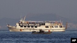 The activist run boat "Audacity of Hope" is escorted by the Greek coast guard in port of Perama, near Athens, Greece, July 1, 2011.