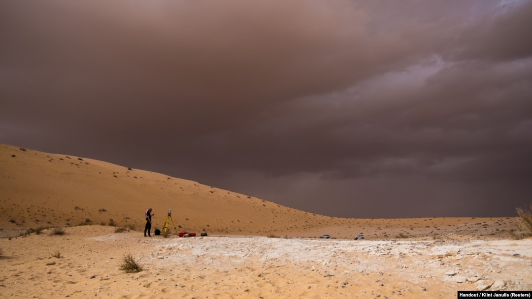 A researcher works on surveying and mapping of the Al Wusta site in the Nefud Desert in Saudi Arabia in this undated handout photo obtained by Reuters April 9, 2018.
