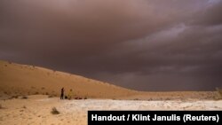 A researcher works on surveying and mapping of the Al Wusta site in the Nefud Desert in Saudi Arabia in this undated handout photo obtained by Reuters April 9, 2018.