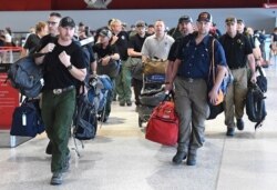 A contingent of 39 firefighters from the United States and Canada arrive at Melbourne Airport in Melbourne, Jan. 2, 2020.
