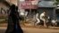 FILE - Muslim women walk in a residential neighborhood in Belagavi, India, Oct. 7, 2021. Police in India have arrested a man alleged to be behind an online 'auction' of pictures of Muslim women in a case of apparent hatred toward the minority community.