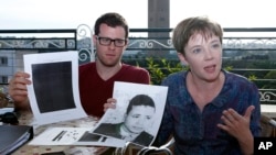 American lawyer, Cori Crider (r) shows a portrait of Younis Abdurrahman Chekkouri a former Guantanamo detainee released from the U.S. detention center, Oct. 22, 2015.