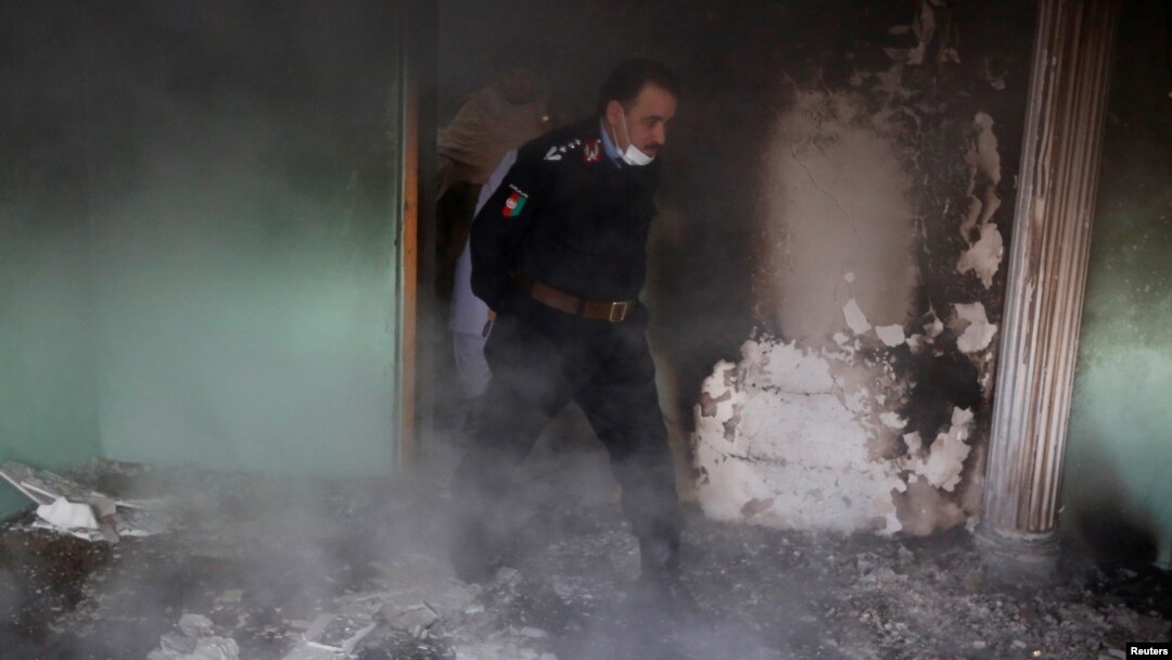 An Afghan police officer inspects the house of an Afghan member of parliament which was attacked by Taliban last night in Kabul, Afghanistan, Dec. 22, 2016. 