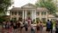 FILE - Fans wait in line outside Graceland, Elvis Presley's Memphis home, in Memphis, Tennessee, Aug. 15, 2017.