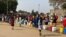 People in Harare forget about social distance to contain coronavirus and get crowded while waiting for free water deliveries from well wishers like Clean City, Aug. 20, 2020. (Columbus Mavhunga/VOA)