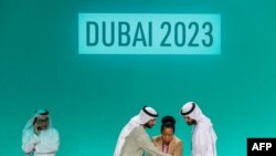 FILE — Officials prepare for a plenary session during the COP28 United Nations climate summit in Dubai on December 13, 2023.