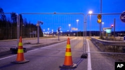 FILE - A view of a fence blocking the road to the closed empty Nuijamaa border station between Russia and Finland in Lappeenranta, Finland, Nov. 18, 2023. 