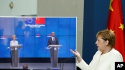 FILE - German Chancellor Angela Merkel holds a video news conference with European Council President Charles Michel, center, and European Commission President Ursula von der Leyen after a virtual summit with China's President Xi Jinping on Sept. 14, 2020.