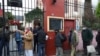 FILE - People line up to receive a ration of stew at a soup kitchen organized at the Caacupe church, during the coronavirus disease (COVID-19) outbreak, in Buenos Aires, Argentina, July 23, 2020.