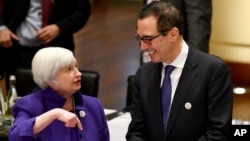 Janet Yellen, president of the Federal Reserve Board, and U.S. Treasury Secretary Steven Mnuchin talk to each other during the G20 finance ministers meeting in Baden-Baden, Germany, March 17, 2017.