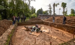 FILE - Archaeologists work at a site of the supposed burial place of French General Charles-Etienne Gudin in Smolensk, Russia, July 7, 2019.