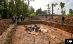 FILE - Archaeologists work at a site of the supposed burial place of French General Charles-Etienne Gudin in Smolensk, Russia, July 7, 2019.