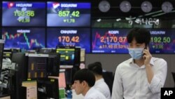 A currency trader talks on the mobile phone at the foreign exchange dealing room of the KEB Hana Bank headquarters in Seoul, South Korea, July 9, 2020.