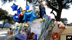 Flores y globos dejados por ciudadanos en el lugar donde fue asesinado el detective de policía de San Antonio, Texas, Benjamin Marconi, el domingo.
