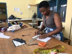 Global Mamas' sewing instructor and technical designer Elizabeth Adams prepares a pattern for the fabric face masks. (Photo Courtesy of Global Mamas)