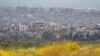 FILE— Destroyed buildings stand in the Gaza Strip as seen from southern Israel, March 18, 2024.