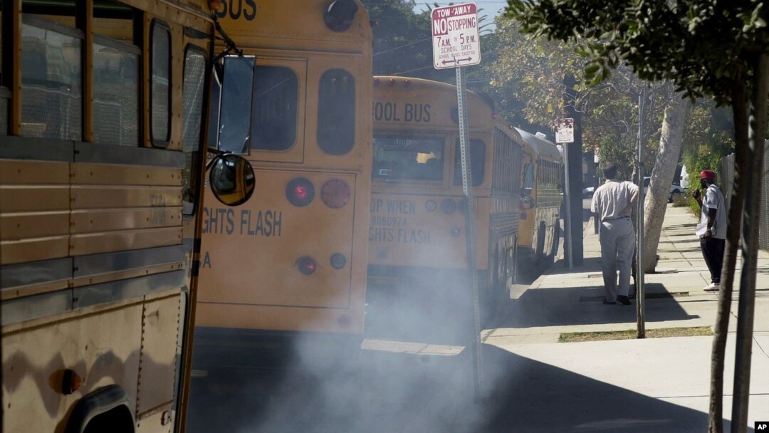 Buses spew diesel-fuel exhaust as they start up and pull away from an elementary school near Los Angeles, September. 6, 2000.