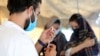 FILE - A doctor fills a syringe with the Johnson & Johnson COVID-19 vaccine at a vaccination center, in Kabul, Afghanistan, July 11, 2021.