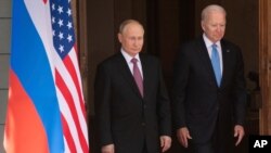 FILE - President Joe Biden and Russian President Vladimir Putin arrive for a meeting on June 16, 2021, in Geneva, Switzerland.