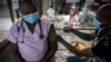 A doctor receives a Johnson & Johnson vaccine at the government hospital in Klerksdorp, South Africa, Thursday, Feb. 18, 2021. 