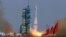 FILE - A rocket loaded with a Shenzhou-9 manned spacecraft lifts off from its launch pad at the Jiuquan Satellite Launch Center, Gansu province June 16, 2012.
