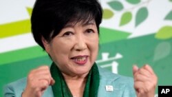 FILE - Incumbent Tokyo Gov. Yuriko Koike celebrates after she was elected for Tokyo's gubernatorial election in Tokyo, July 7, 2024. 