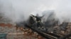 A rescuer of the State Emergency Service works to put out a fire in a private house after a drone strike in Kharkiv, Ukraine, on Dec. 25, 2024.