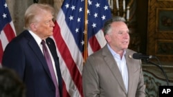 FILE - President Donald Trump listens to Steve Witkoff speak during a news conference at Mar-a-Lago, Jan. 7, 2025, in Palm Beach, Florida.