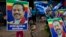 Supporters of Sri Lanka's former president and parliamentary candidate Mahinda Rajapaksa display his posters to mark conclusion of voting in Colombo, Sri Lanka, Aug. 17, 2015