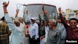 People from India’s low-caste community shout slogans as they block traffic during a protest against the flogging of four men accused of skinning a cow, in Ahmedabad, India, July 20, 2016. 