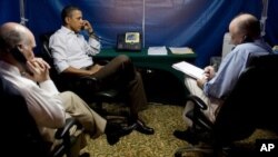 President Barack Obama is briefed on the situation in Libya during a secure conference call that included National Security Adviser Tom Donilon, right, and Chief of Staff Bill Daley, left.