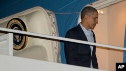 President Barack Obama boards Air Force One before his departure from Andrews Air Force Base, Sunday, March 23, 2014. 