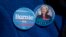 FILE - A demonstrator wears Democratic presidential candidate's Sen. Bernie Sanders, I-Vt., and Hillary Clinton buttons during a rally in New York, March 31, 2016.