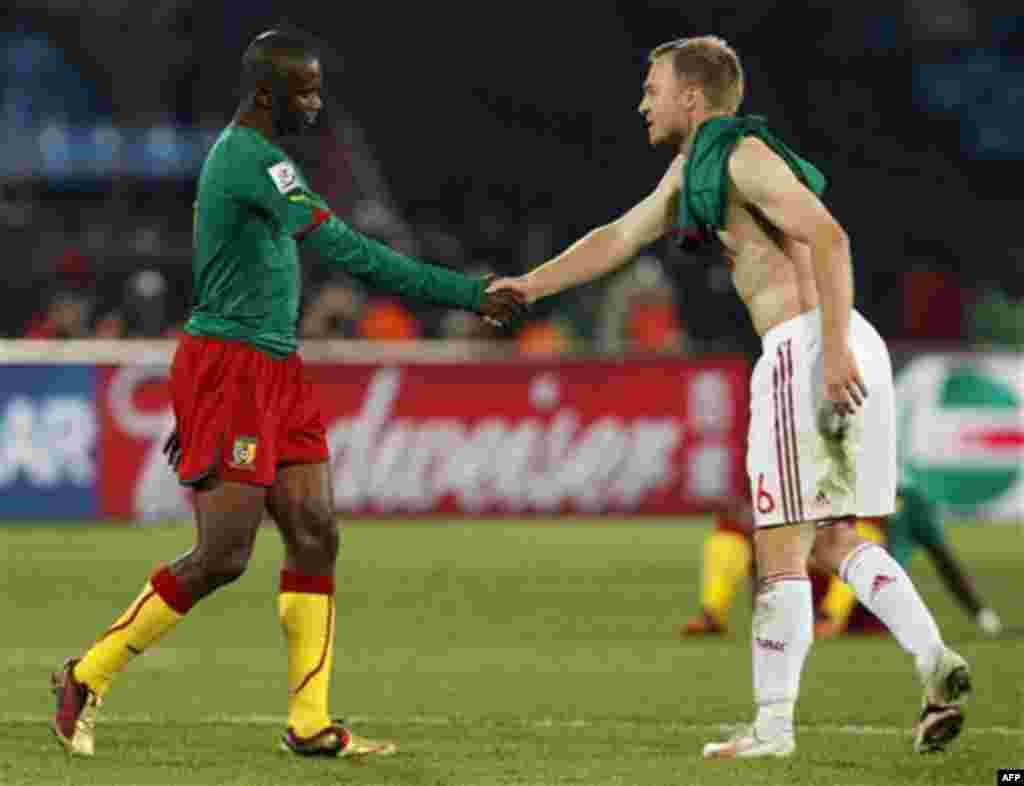 Cameroon's Samuel Eto'o, left, shakes hands with Denmark's Lars Jacobsen, right, following the World Cup group E soccer match between Cameroon and Denmark at the Loftus Versfeld Stadium in Pretoria, South Africa, Saturday, June 19, 2010. Denmark won 2-1. 