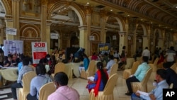Candidates seeking employment wait to attend interviews during a job fair conducted by Hyderabad city police in Hyderabad, India, July 24, 2021.