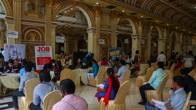 Candidates seeking employment wait to attend interviews during a job fair conducted by Hyderabad city police in Hyderabad, India, July 24, 2021.