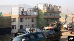 Afghan security forces inspect the site of an attack in Kabul, Afghanistan, Nov. 28, 2014. 