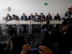 Former rebel commanders hold a press conference after appearing at a special peace tribunal to testify in an ongoing probe of their role in civilian kidnappings in Bogota, Colombia, Sept. 23, 2019.