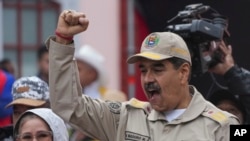 President Nicolas Maduro gestures to supporters during an event marking the 165th anniversary of the Battle of Santa Ines, in Caracas, Venezuela, Dec. 10, 2024. 