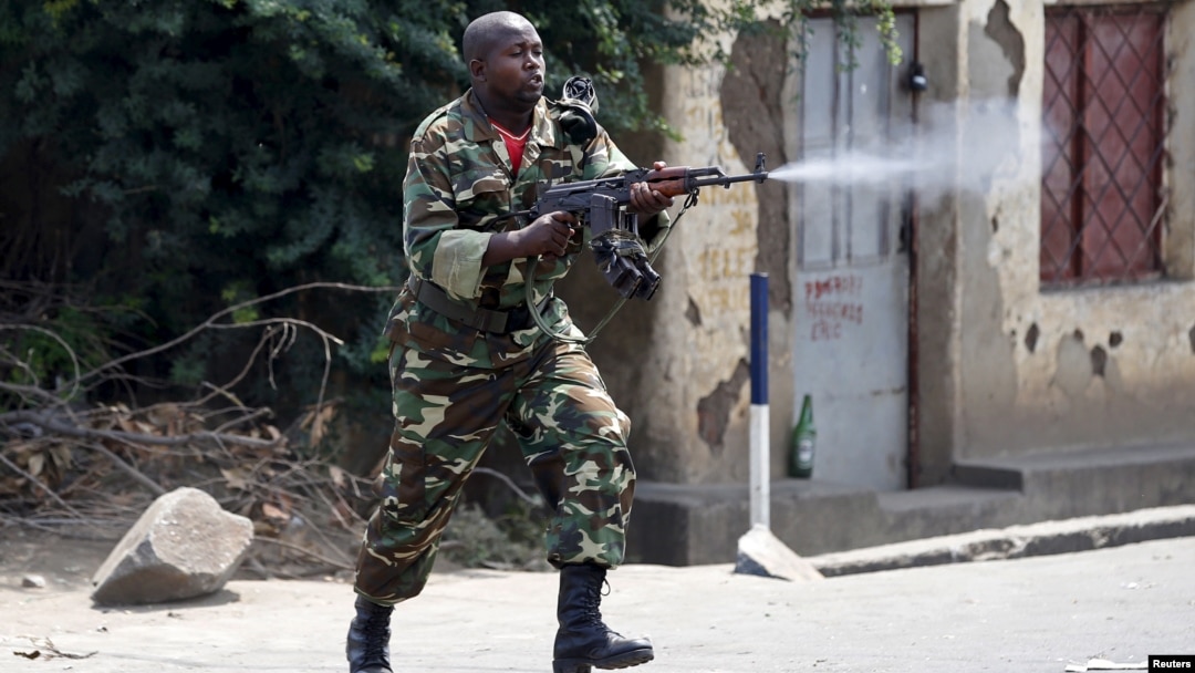 Seorang tentara Burundi dengan senjata AK-47 menembak ke arah demonstran dalam protes menentang Presiden Pierre Nkurunziza di Bujumbura, Burundi (25/5).