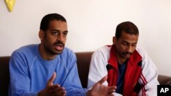FILE - In this March 30, 2019, photo, Alexanda Amon Kotey, left, and El Shafee Elsheikh, who were allegedly among four British jihadis who made up a brutal IS cell dubbed "The Beatles," speak with The Associated Press.
