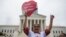 Antonio Surco of Silver Spring, Md. participates in a demonstration outside the Supreme Court in Washington, June 23, 2016. 