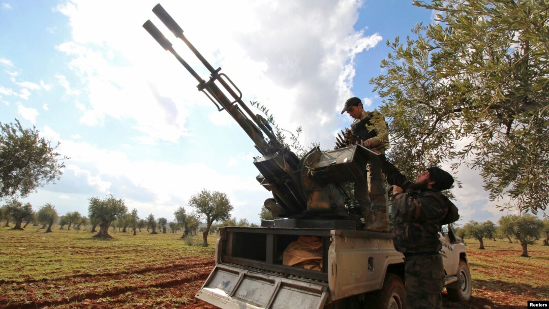 FILE - Rebel fighters man an anti-aircraft weapon at the front line against forces loyal to Syria's President Bashar al-Assad in Ratian village, north of Aleppo, Feb. 17, 2015. 