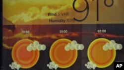 A man walks past a screen that displays the weather forecast and temperature in New York's Times Square. Temperatures were expected to reach near record levels Thursday as a heat wave spread east from the nation's midsection, July 21, 2011