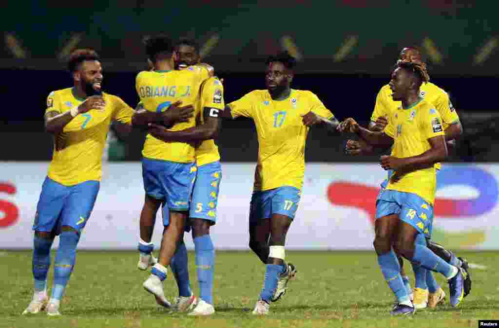 Gabon&#39;s players celebrate their team&#39;s first goal during the match Burkina Faso vs Gabon in Cameroon on Jan. 23, 2022.