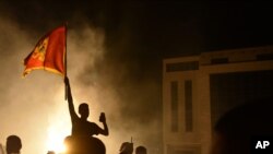 Supporters of opposition groups celebrate after polls closed in Montenegro's parliamentary elections in Podgorica, Montenegro, early Aug. 31, 2020.