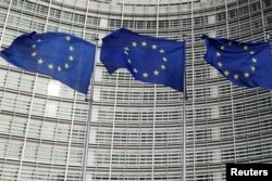 EU flags fly outside the European Commission in Brussels