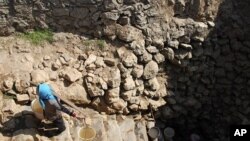 A farmer carrying water collected from a nearly dried-up well climbs a stairs at a village in Xiping county, Yunnan province, February 22, 2012.